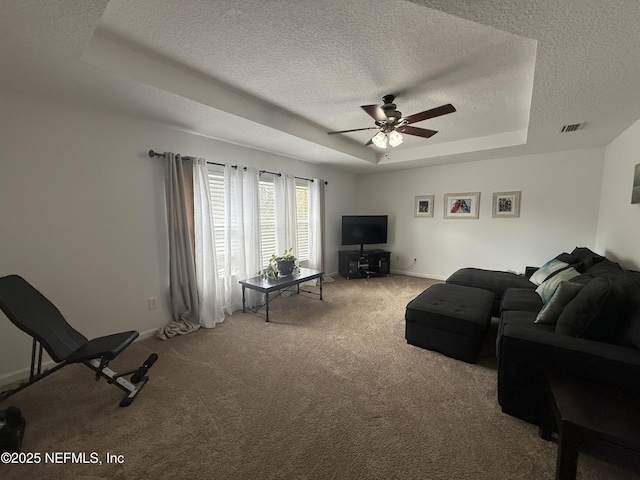 305 Carriage Hill Ct, Saint Johns, FL 32259 - carpeted living room featuring a tray ceiling, a textured ceiling, a ceiling fan, and baseboards