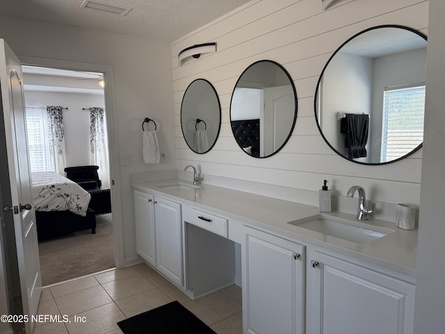 305 Carriage Hill Ct, Saint Johns, FL 32259 - full bath featuring healthy amount of natural light, double vanity, ensuite bath, a textured ceiling, and tile patterned floors