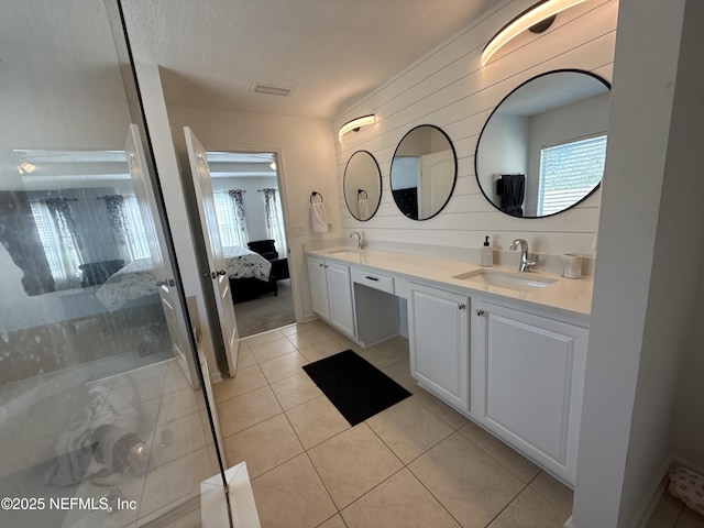 305 Carriage Hill Ct, Saint Johns, FL 32259 - ensuite bathroom with double vanity, tile patterned floors, and a textured ceiling