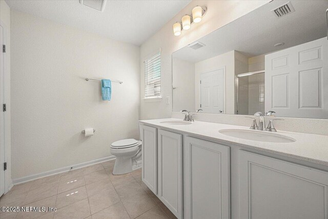 403 Boulder Ln, Jacksonville, FL 32259 - bathroom with a shower stall, baseboards, toilet, double vanity, and tile patterned floors