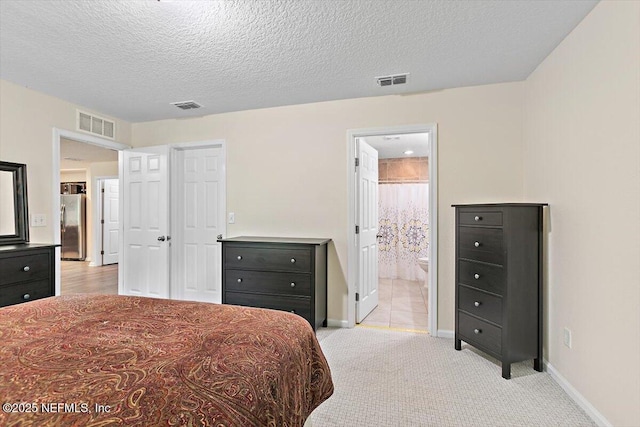 4116 Adirolf Rd, Jacksonville, FL 32207 - bedroom featuring freestanding refrigerator, baseboards, light colored carpet, a textured ceiling, and connected bathroom
