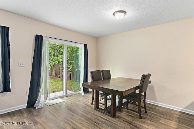 4116 Adirolf Rd, Jacksonville, FL 32207 - dining area featuring wood finished floors, baseboards, and a textured ceiling