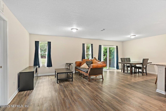 4116 Adirolf Rd, Jacksonville, FL 32207 - living area featuring dark wood-style flooring, baseboards, and a textured ceiling