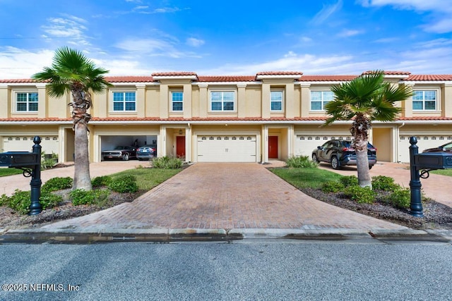 1684 Sanctuary Way, Fleming Island, FL 32003 - view of front of property with driveway, stucco siding, a tile roof, and an attached garage