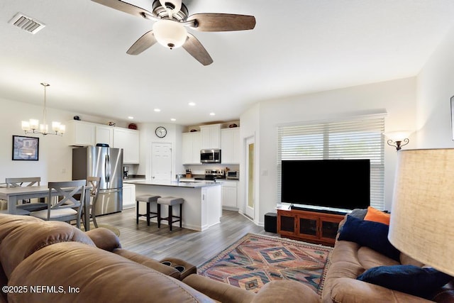 1684 Sanctuary Way, Fleming Island, FL 32003 - living area with a chandelier, a ceiling fan, light wood finished floors, and recessed lighting