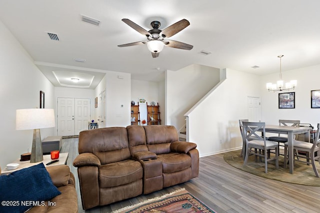 1684 Sanctuary Way, Fleming Island, FL 32003 - living room featuring stairs, wood finished floors, a ceiling fan, a chandelier, and baseboards