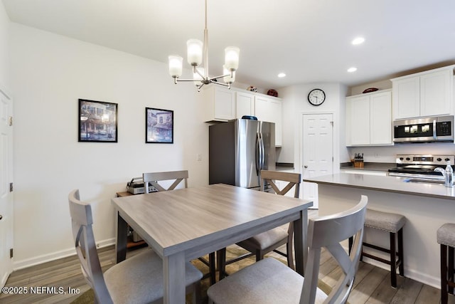 1684 Sanctuary Way, Fleming Island, FL 32003 - dining space with wood finished floors, a chandelier, recessed lighting, and baseboards