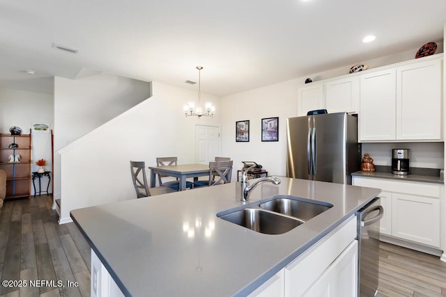 1684 Sanctuary Way, Fleming Island, FL 32003 - kitchen with freestanding refrigerator, a sink, wood finished floors, a chandelier, and recessed lighting