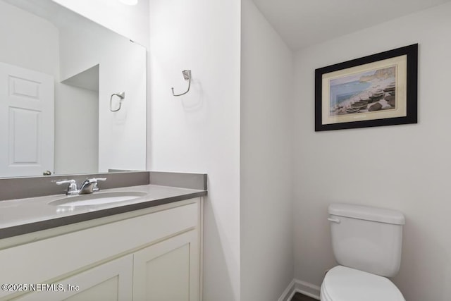 1684 Sanctuary Way, Fleming Island, FL 32003 - bathroom featuring toilet, vanity, and baseboards