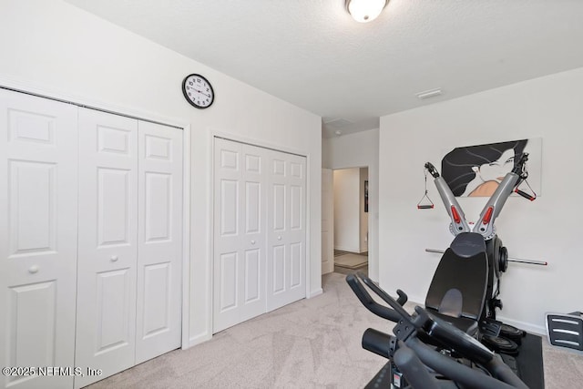 1684 Sanctuary Way, Fleming Island, FL 32003 - workout room with carpet flooring, baseboards, and a textured ceiling
