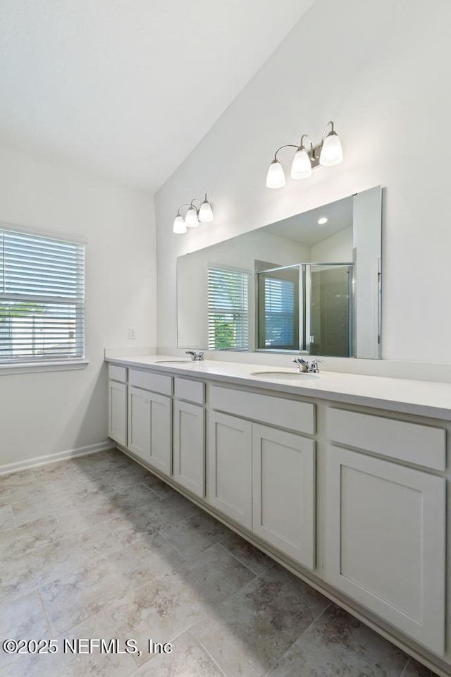1684 Sanctuary Way, Fleming Island, FL 32003 - bathroom featuring a shower stall, plenty of natural light, double vanity, and baseboards