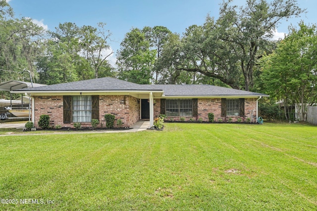 884 Live Oak Ln, Fleming Island, FL 32003 - view of front of house with brick siding, a carport, and roof with shingles