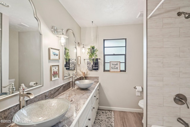 884 Live Oak Ln, Fleming Island, FL 32003 - bathroom with wood finished floors, double vanity, and a tile shower