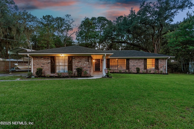 884 Live Oak Ln, Fleming Island, FL 32003 - ranch-style home featuring a lawn, a detached carport, and brick siding