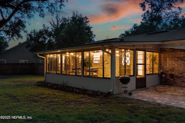 884 Live Oak Ln, Fleming Island, FL 32003 - back of house featuring a sunroom, a patio area, and brick siding