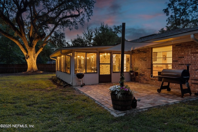 884 Live Oak Ln, Fleming Island, FL 32003 - rear view of property featuring a sunroom, a patio, and brick siding