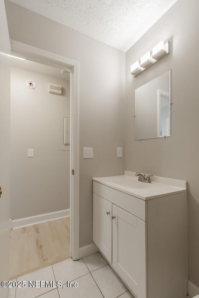 1050 Assisi Ln, Jacksonville, FL 32233 - bathroom featuring vanity, a textured ceiling, baseboards, and tile patterned floors