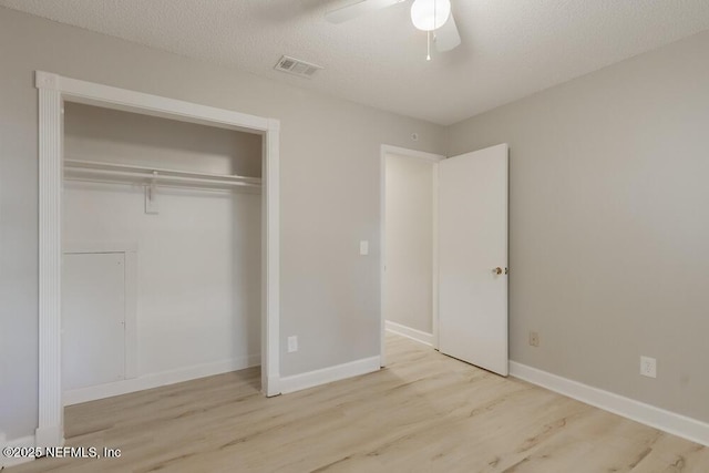 1050 Assisi Ln, Jacksonville, FL 32233 - unfurnished bedroom featuring wood finished floors, a closet, baseboards, ceiling fan, and a textured ceiling