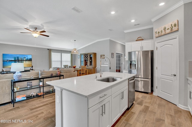 328 Falcon Quest Ln, Saint Augustine, FL 32095 - kitchen with stainless steel appliances, a sink, wood tiled floors, ceiling fan, and crown molding