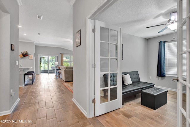 328 Falcon Quest Ln, Saint Augustine, FL 32095 - unfurnished room with wood finished floors, baseboards, a ceiling fan, a textured ceiling, and lofted ceiling