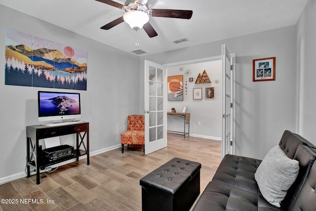 328 Falcon Quest Ln, Saint Augustine, FL 32095 - living room featuring french doors, wood finished floors, baseboards, and a textured ceiling