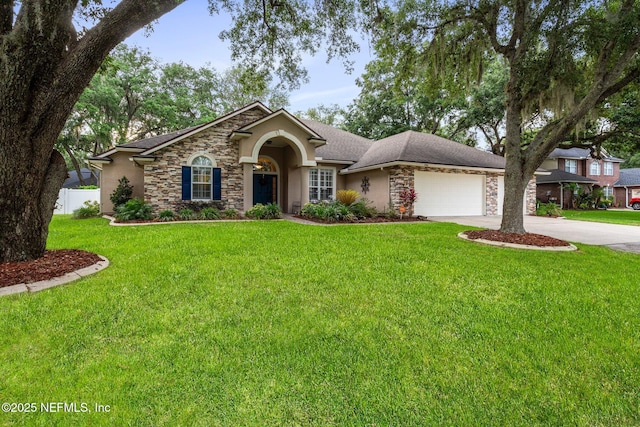 3746 Cardinal Oaks Cir, Orange Park, FL 32065 - view of front of home with stone siding, an attached garage, driveway, and stucco siding