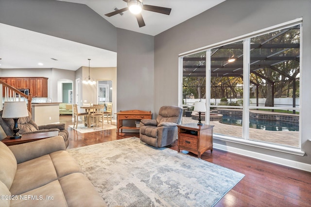 3746 Cardinal Oaks Cir, Orange Park, FL 32065 - living area with ceiling fan, dark wood-type flooring, arched walkways, baseboards, and a chandelier