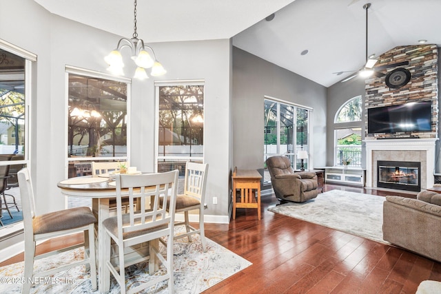 3746 Cardinal Oaks Cir, Orange Park, FL 32065 - dining space featuring vaulted ceiling, wood finished floors, a tile fireplace, a chandelier, and ceiling fan