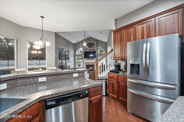 3746 Cardinal Oaks Cir, Orange Park, FL 32065 - kitchen with stainless steel appliances, lofted ceiling, dark wood-style floors, dark countertops, and open floor plan