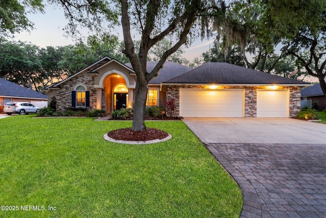 3746 Cardinal Oaks Cir, Orange Park, FL 32065 - ranch-style house featuring stone siding, driveway, and a garage