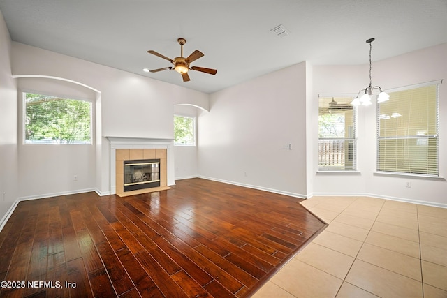 337 Bell Branch Ln, Saint Johns, FL 32259 - unfurnished living room featuring ceiling fan, wood finished floors, a tile fireplace, and baseboards