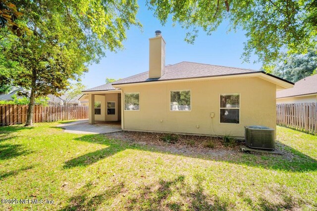 337 Bell Branch Ln, Saint Johns, FL 32259 - back of house featuring central AC unit, a patio, a chimney, stucco siding, and roof with shingles
