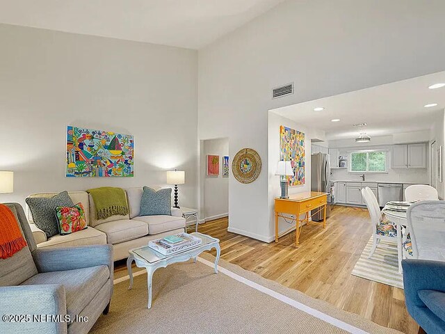 2700 Mizell Ave Unit 402B, Fernandina Beach, FL 32034 - living area with light wood-type flooring, baseboards, and recessed lighting