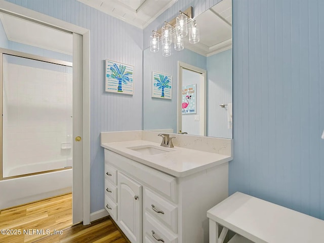 2700 Mizell Ave Unit 402B, Fernandina Beach, FL 32034 - bathroom featuring vanity, ornamental molding, wood finished floors, and shower / washtub combination