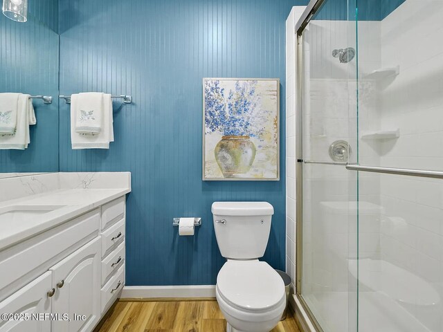 2700 Mizell Ave Unit 402B, Fernandina Beach, FL 32034 - bathroom with wood finished floors, a shower stall, vanity, and toilet