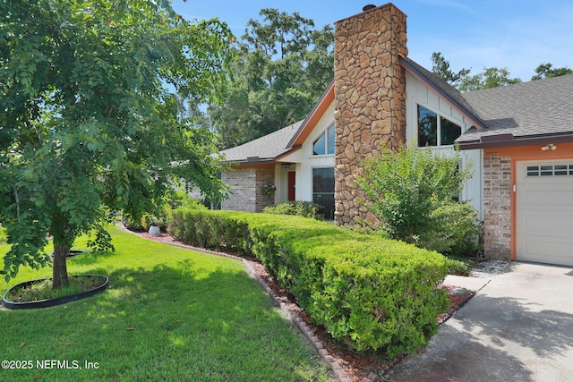 5604 Swamp Fox Rd, Jacksonville, FL 32210 - view of side of home with a shingled roof, a yard, brick siding, and a chimney