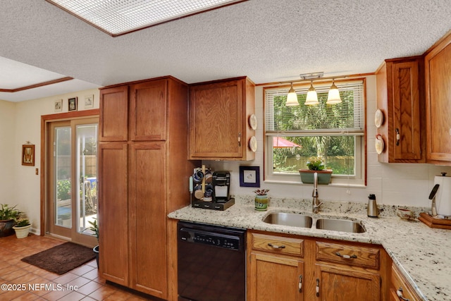 5604 Swamp Fox Rd, Jacksonville, FL 32210 - kitchen with dishwasher, a sink, brown cabinets, light stone countertops, and a textured ceiling