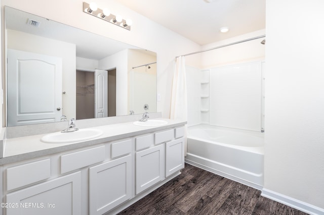 2719 Oak Stream Dr, Green Cove Springs, FL 32043 - bathroom with double vanity, shower / bathtub combination with curtain, and wood finished floors