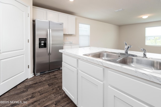 2719 Oak Stream Dr, Green Cove Springs, FL 32043 - kitchen with stainless steel fridge with ice dispenser, a sink, dark wood-style flooring, white cabinets, and washing machine and clothes dryer