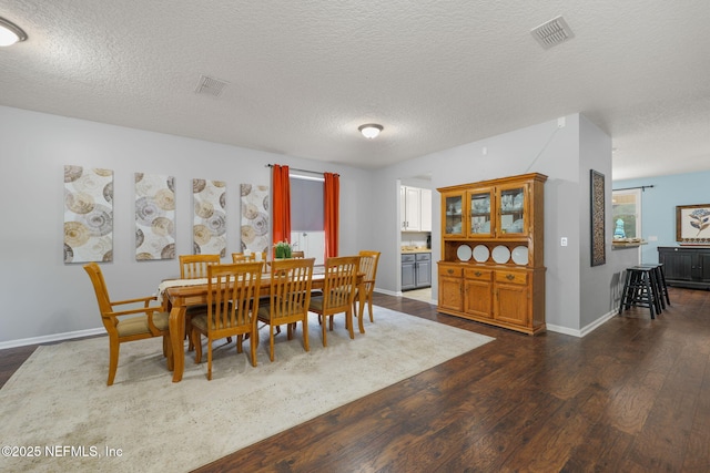 521 Cedar Arbor Ct, Saint Augustine, FL 32084 - dining area with dark wood-style floors, a textured ceiling, and baseboards