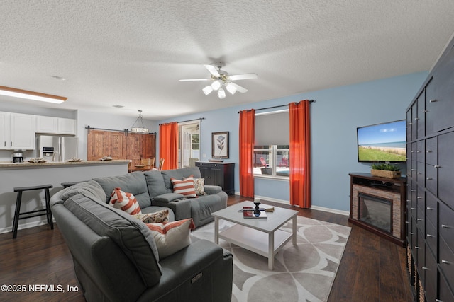521 Cedar Arbor Ct, Saint Augustine, FL 32084 - living area featuring dark wood-type flooring, a textured ceiling, a ceiling fan, and baseboards