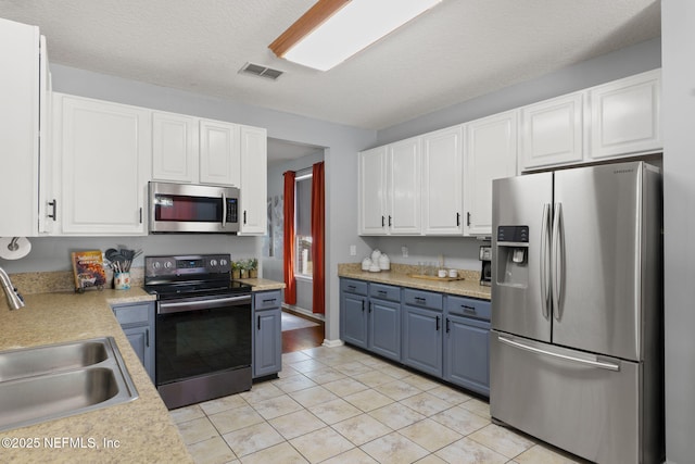 521 Cedar Arbor Ct, Saint Augustine, FL 32084 - kitchen with stainless steel appliances, a sink, light countertops, and white cabinetry