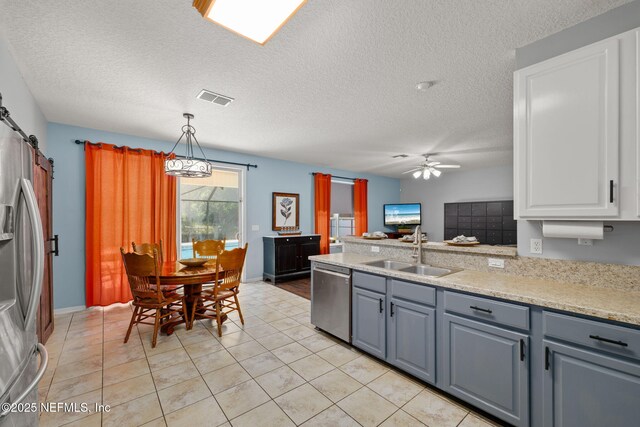 521 Cedar Arbor Ct, Saint Augustine, FL 32084 - kitchen featuring stainless steel appliances, a sink, gray cabinets, a ceiling fan, and white cabinetry