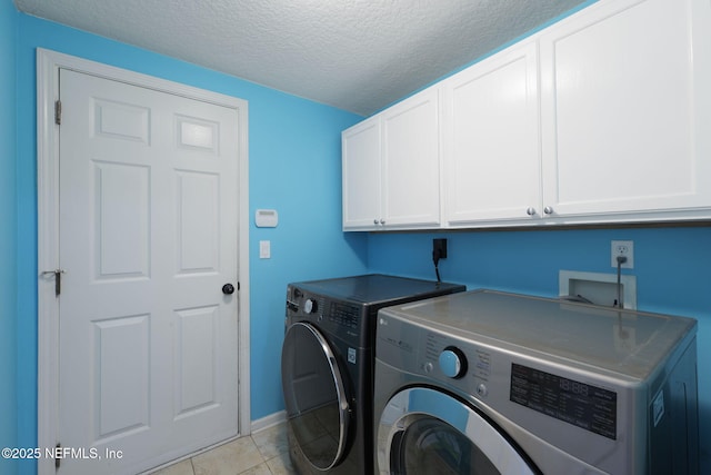 521 Cedar Arbor Ct, Saint Augustine, FL 32084 - laundry area with cabinet space, independent washer and dryer, a textured ceiling, light tile patterned flooring, and baseboards
