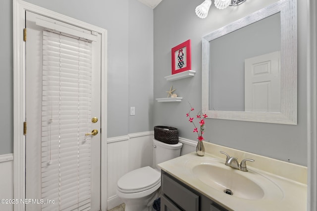 521 Cedar Arbor Ct, Saint Augustine, FL 32084 - bathroom featuring a wainscoted wall, vanity, and toilet