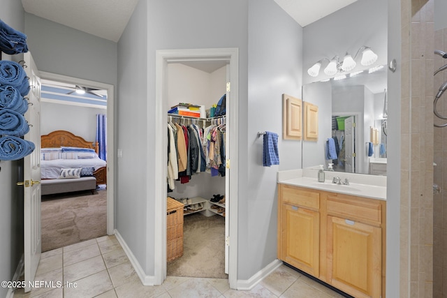 521 Cedar Arbor Ct, Saint Augustine, FL 32084 - ensuite bathroom featuring vanity, tile patterned floors, a spacious closet, and baseboards
