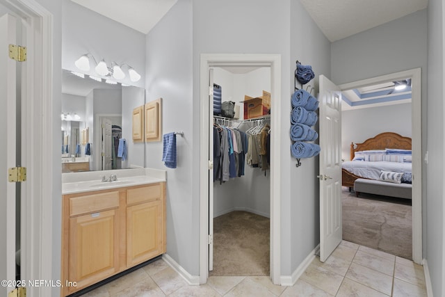 521 Cedar Arbor Ct, Saint Augustine, FL 32084 - bathroom with ensuite bath, vanity, a walk in closet, tile patterned floors, and baseboards
