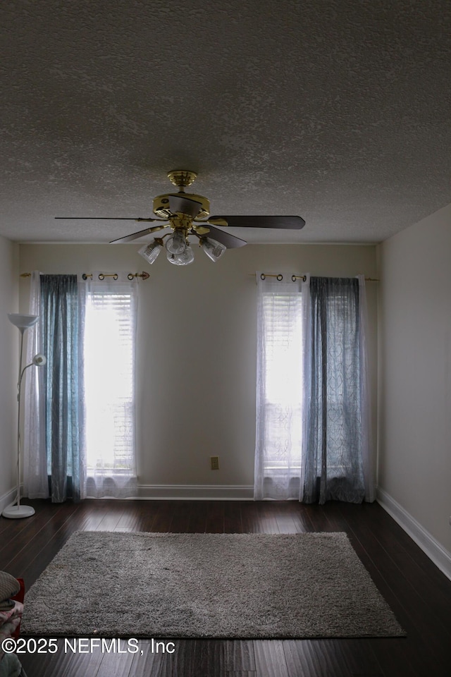 7589 Ginger Tea Trl W, Jacksonville, FL 32244 - unfurnished room with baseboards, hardwood / wood-style floors, ceiling fan, and a textured ceiling