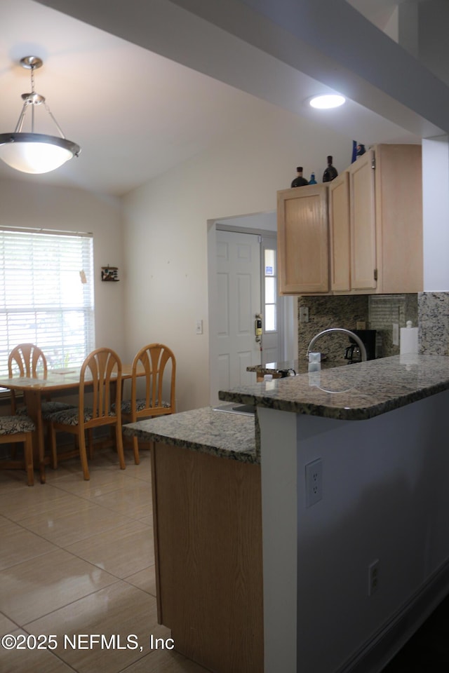 7589 Ginger Tea Trl W, Jacksonville, FL 32244 - kitchen with a peninsula, dark stone countertops, healthy amount of natural light, backsplash, and vaulted ceiling