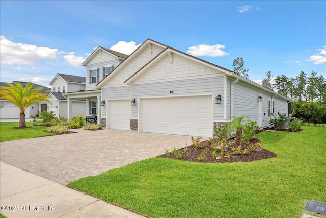 199 Ranch Land Cir, Saint Johns, FL 32259 - craftsman house with driveway, a front lawn, a garage, and stone siding